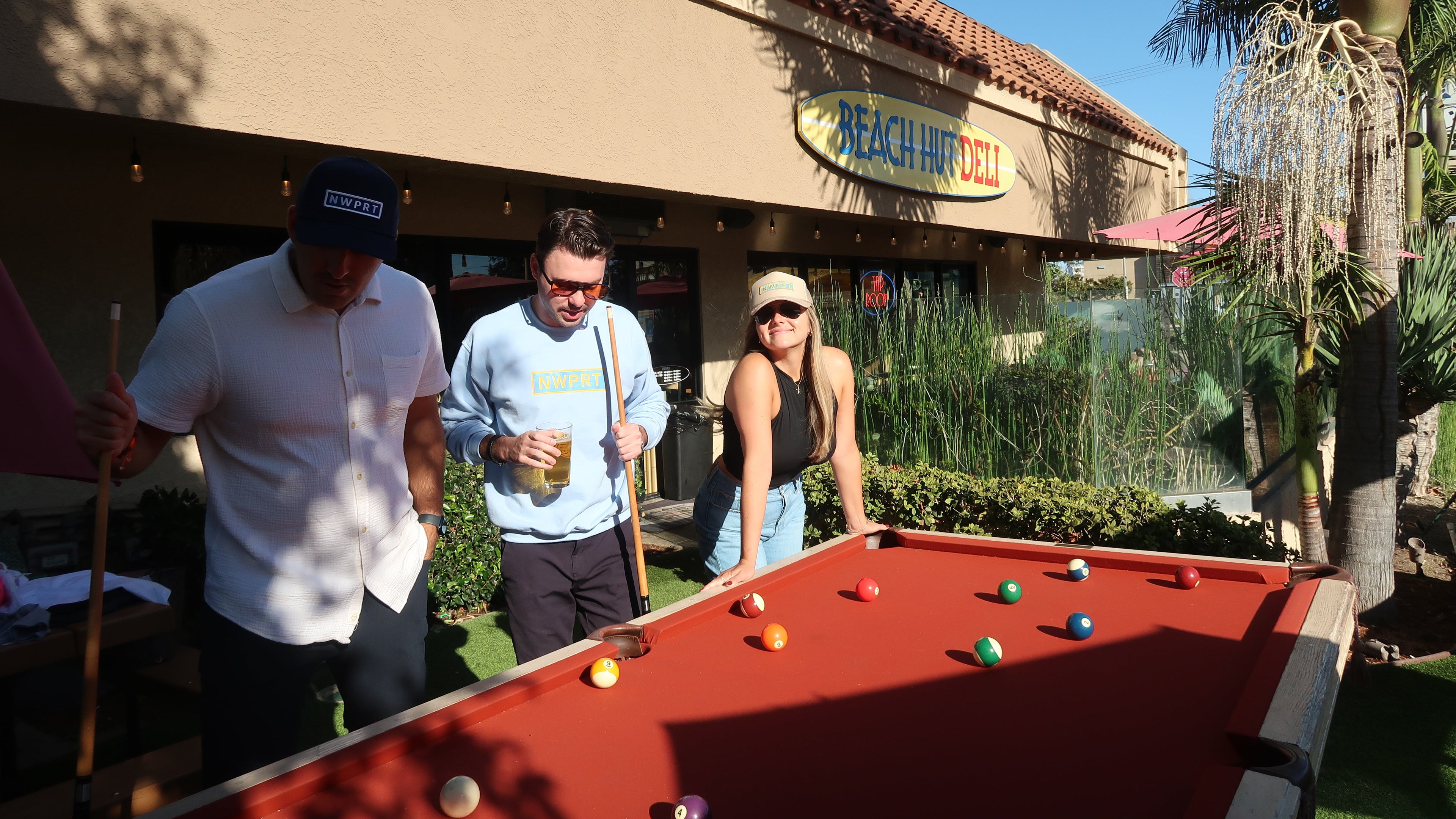 People playing pool outside at Beach Hut Deli.