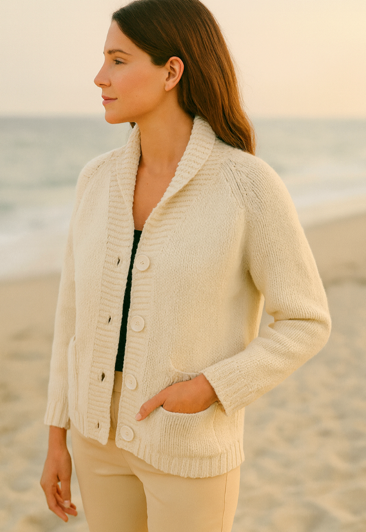Woman wearing a NWPRT beige cardigan on a beach